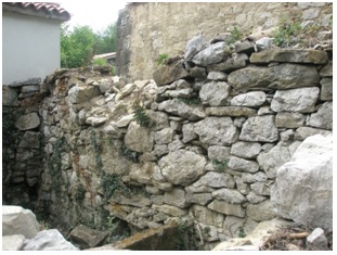 Zadnja stena svinjaka  hkrati obodni suhi zid dvorišča je v slabem stanju